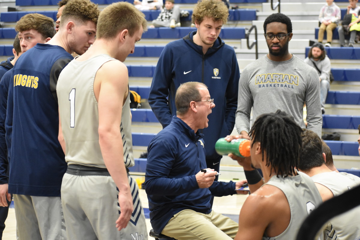 Marian basketball coach Scott Heady coaches his team during a timeout. 